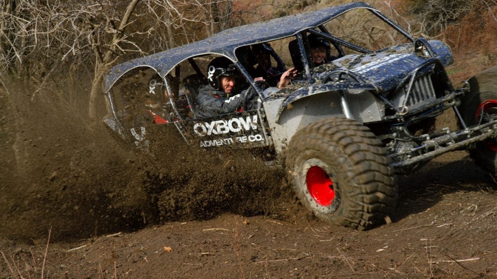 Off-road vehicle in action with happy adventurers driving