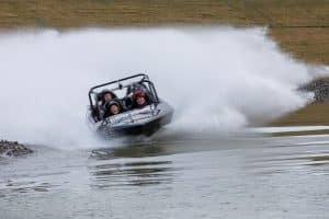 Jet sprint boat in action with thrilled adventurers