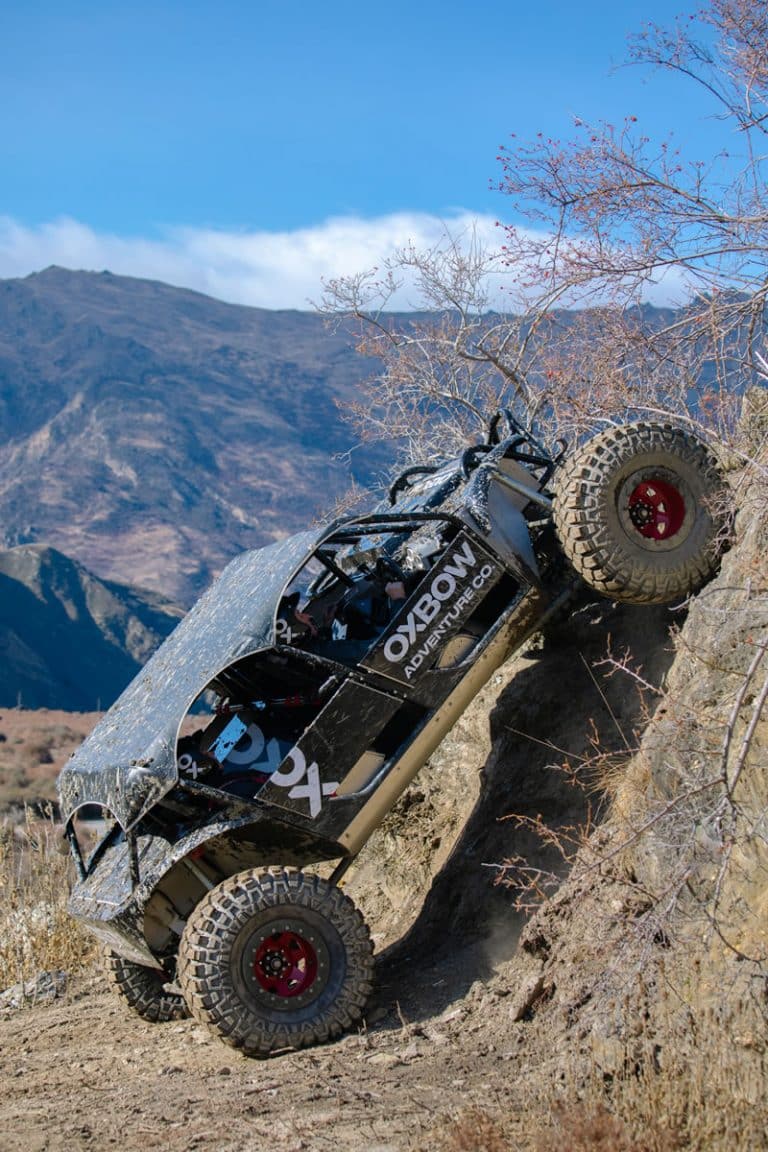 Off-road vehicle in full action going up a steep piece of terrain